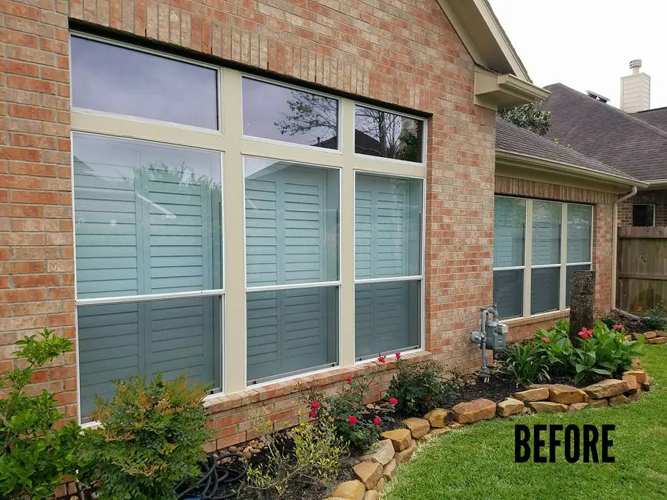 Residential home exterior with flower bed.